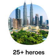 An image showing the Kuala Lumpur skyline with the iconic Petronas Towers in the background and lush greenery in the foreground